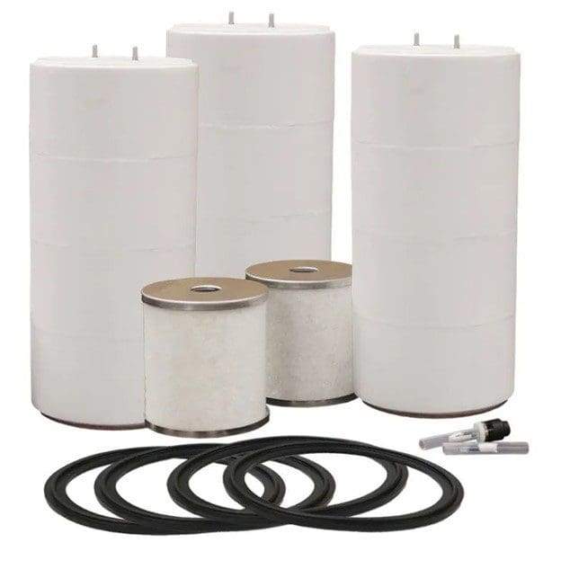 A group of four white cylinders and two black rings.