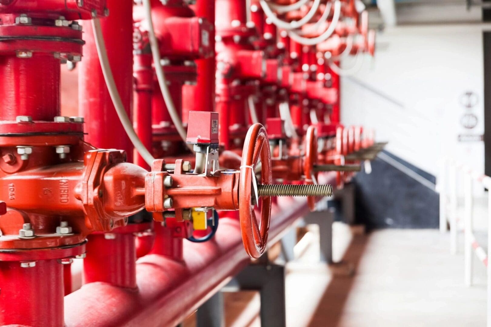 A red pipe system with many pipes connected to it.