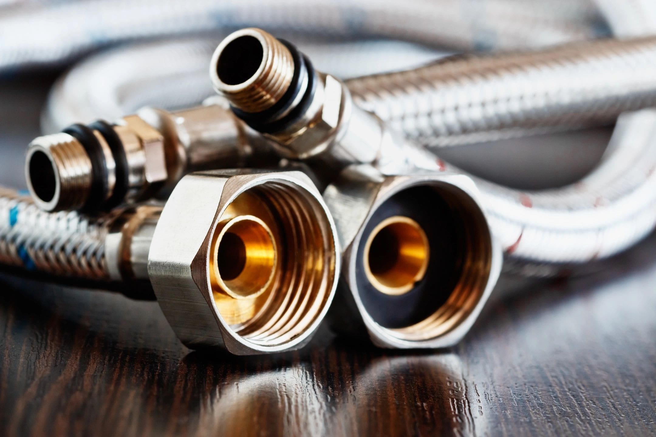 Two pipes with a hose connected to them on the table.