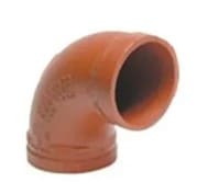 Orange 90-degree pipe fitting for plumbing.