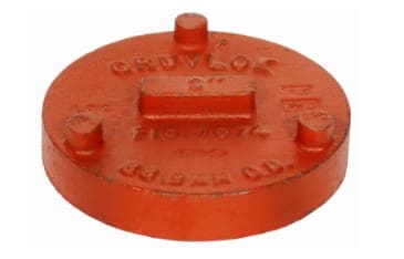 Red, round, metal fire hydrant cap.