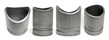 Four metal U-shaped pipe spacers.