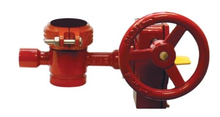 Red fire hydrant valve with a wheel handle.